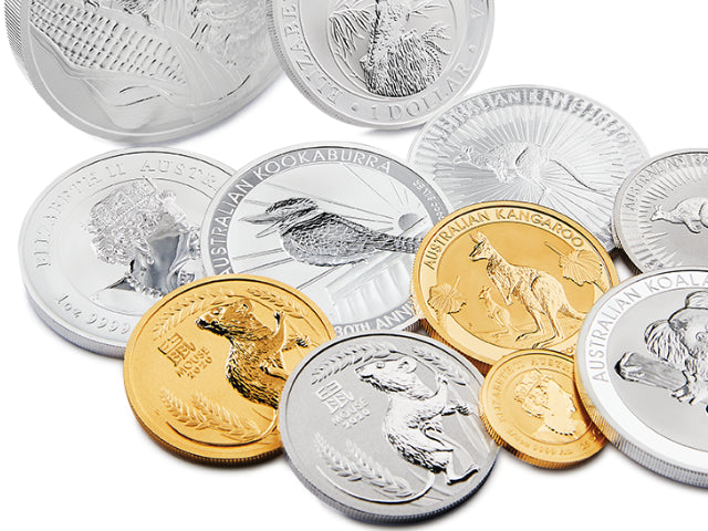 Perth Mint kangaroo, kookaburra and koala, gold and silver coins scattered on a white surface