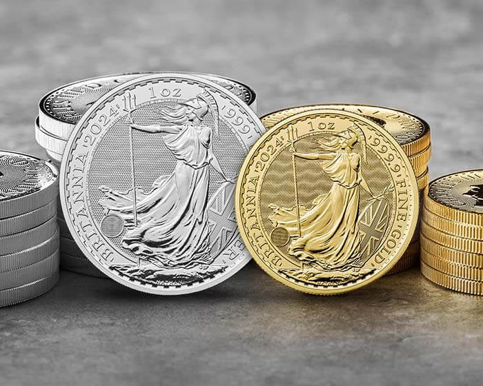 Britannia silver and gold coins stacked on a gray surface