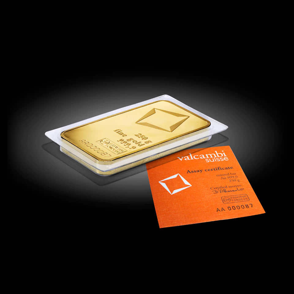 Gold bar with Valcambi Suisse certificate on a black background