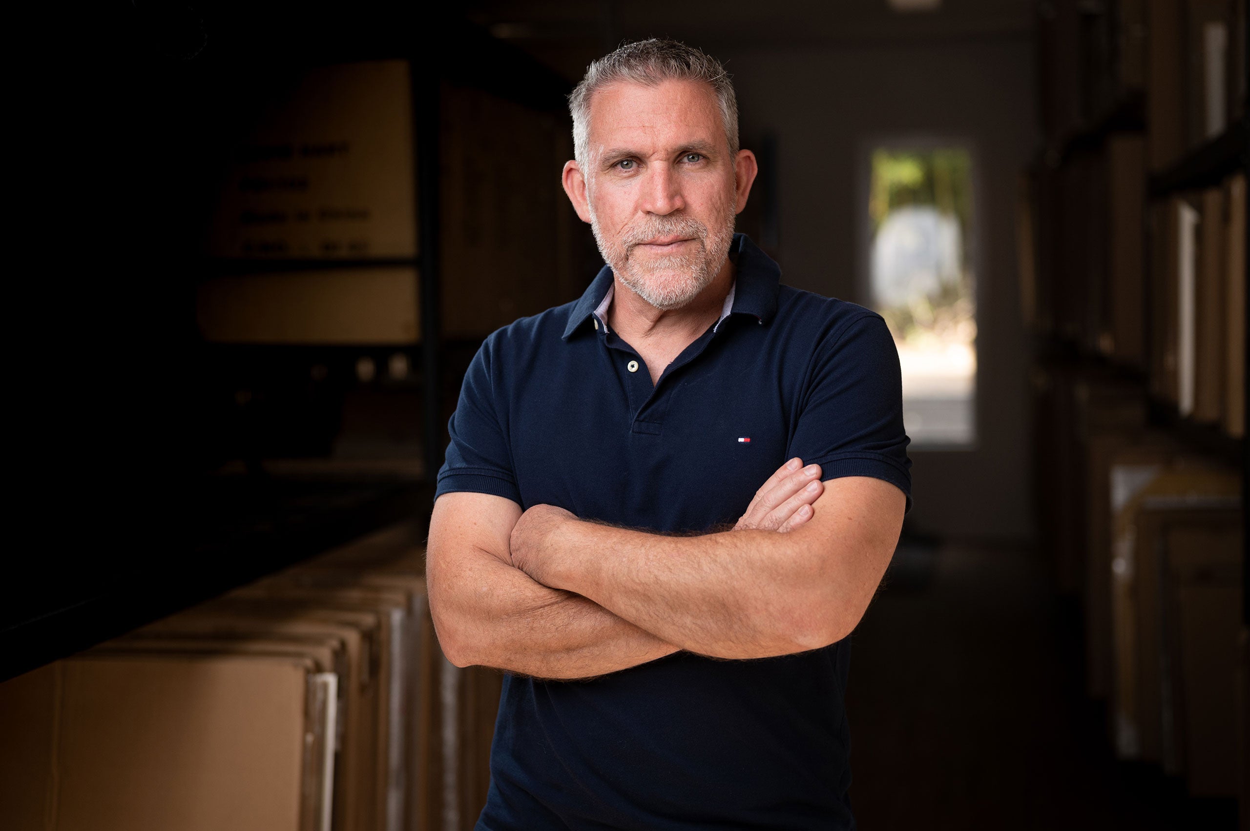 David Hart standing with arms crossed in a warehouse